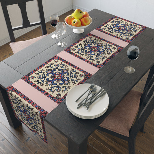 Cream Armenian floral table runner on a dining table with wooden chairs and a bowl of fruit