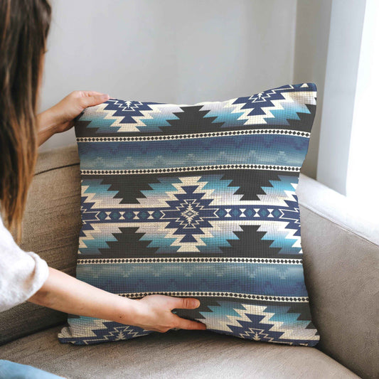 Southwestern throw pillow with geometric pattern styled on a sofa or bed