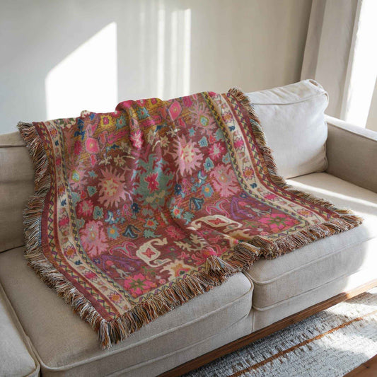 Boho woven blanket with rug-style pattern styled for layered home decor