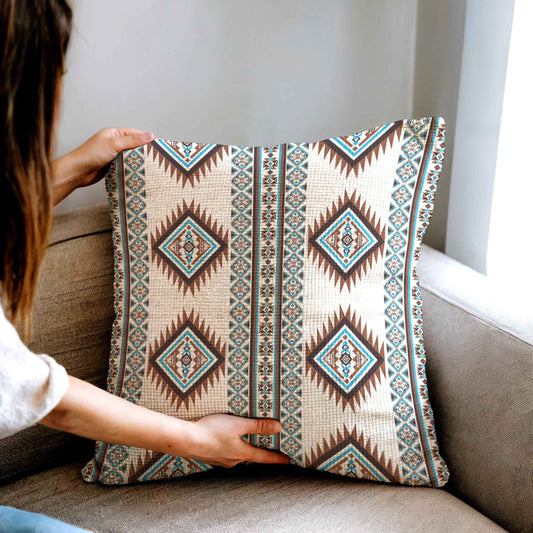 Southwestern throw pillow with geometric pattern styled on a sofa or bed