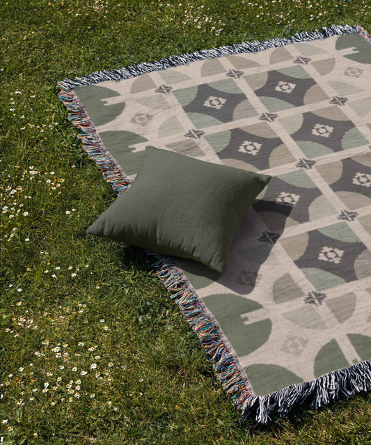 Scandinavian Inspired woven blanket with geometric pattern styled for layered home decor
