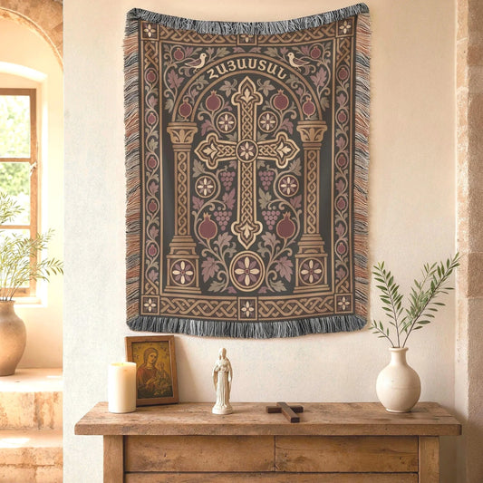 Armenian cross woven wall tapestry above a wooden console with a lit candle and a small figurine