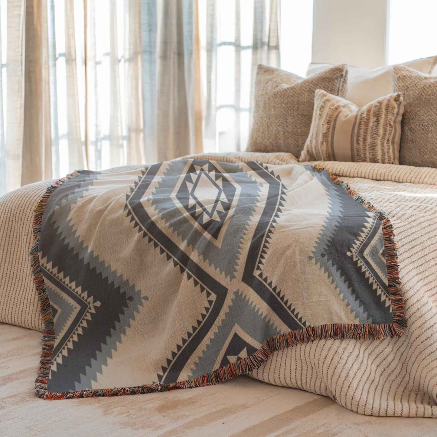 Southwestern woven blanket with geometric pattern styled for layered home decor