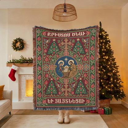 Armenian Nativity blanket held open in front of a Christmas tree, showing the full woven scene