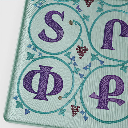 Close view of purple Armenian letters in teal circles of leaves with small grape clusters