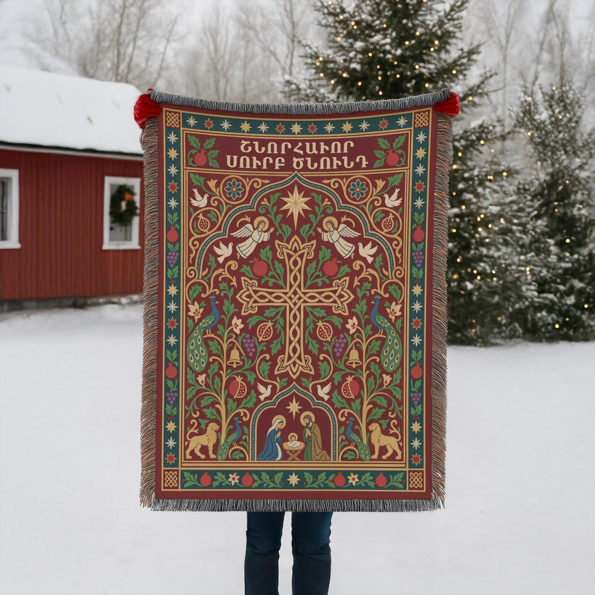 Armenian cross and Nativity woven blanket held up outdoors in the snow beside a red building with Christmas lights