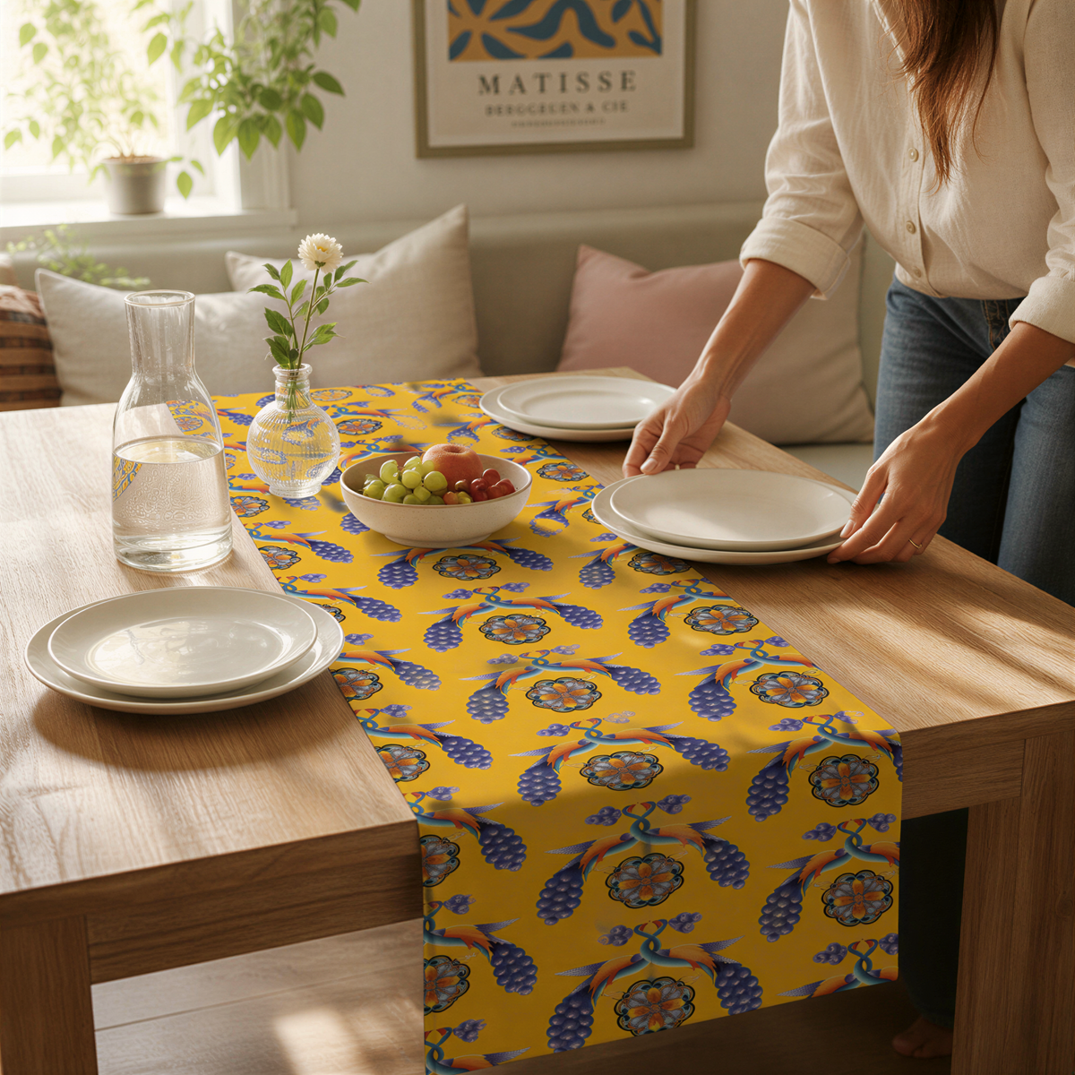 Yellow Armenian bird table runner on a dining table set with white plates and glasses