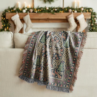 Armenian cross Christmas woven cotton blanket in dark green and gold, shown in a styled room setting