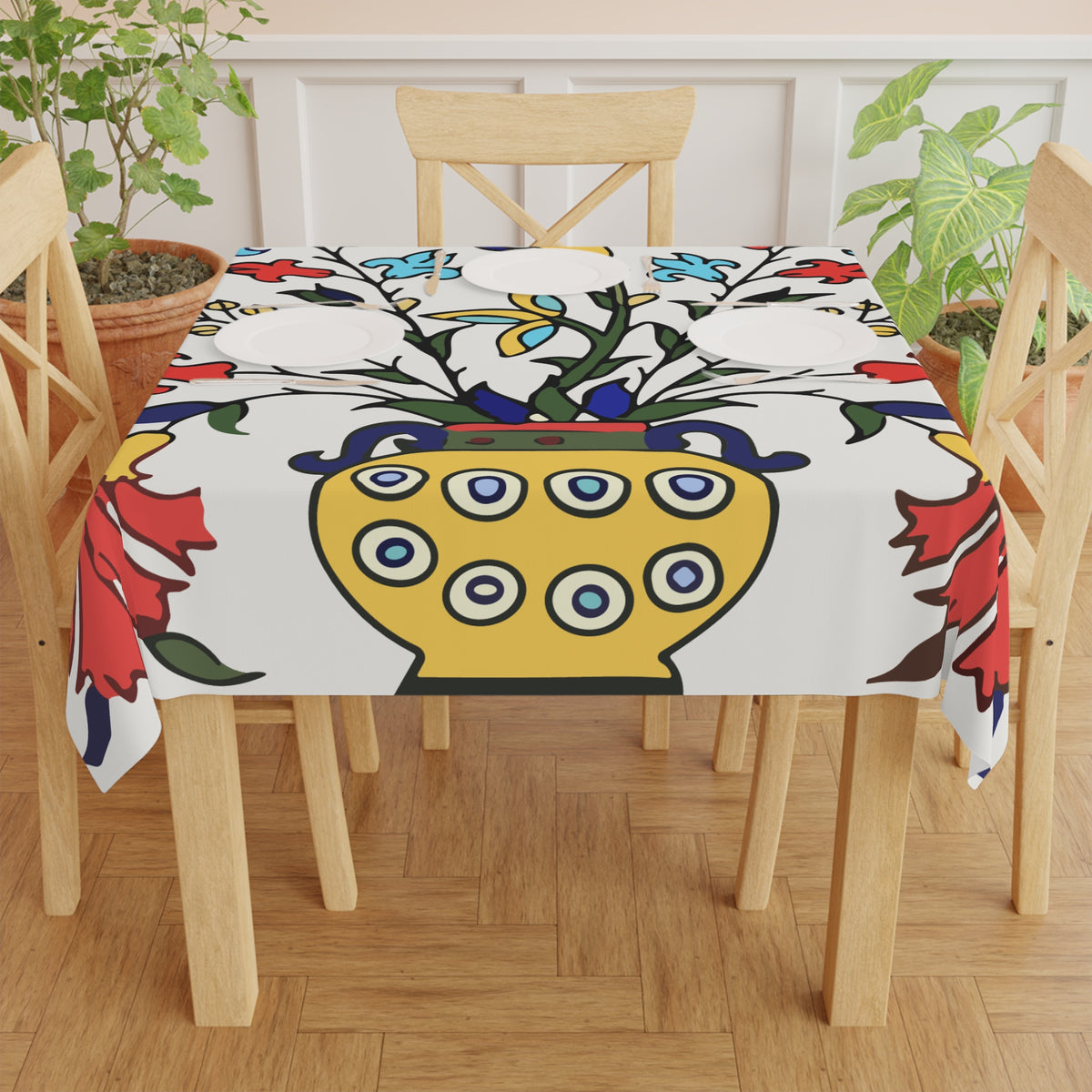 Yellow peacock Armenian tablecloth draped over a round table beside a window