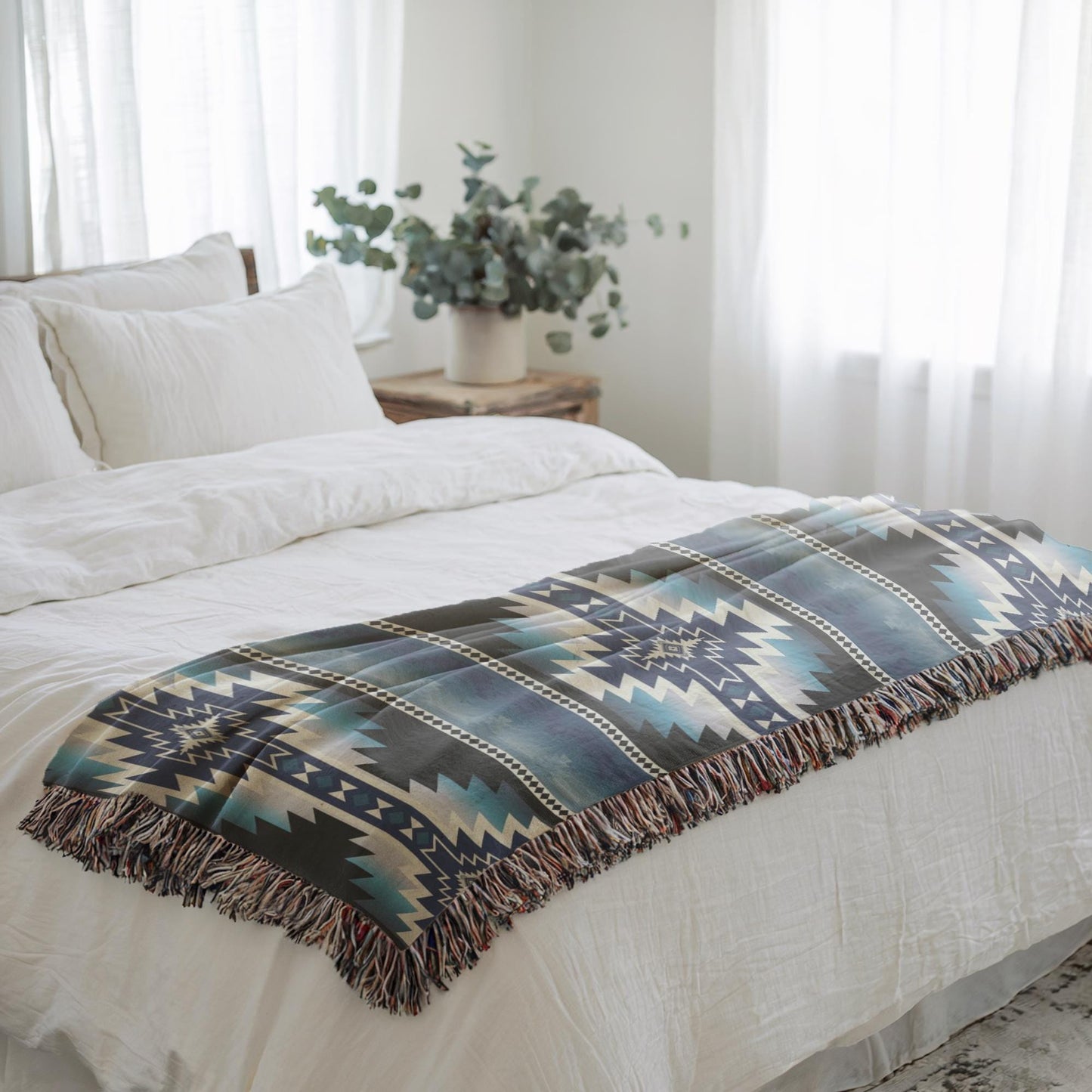 Southwestern woven blanket with geometric pattern styled for layered home decor