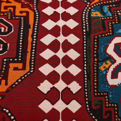 Close view of the burgundy carpet design with cream diamonds and orange and blue medallions