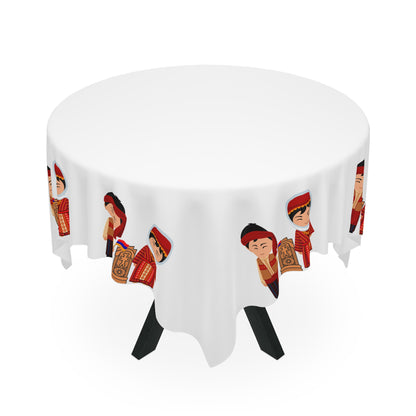 Armenian folk tablecloth with dress figures on a rectangular table with wooden chairs and house plants
