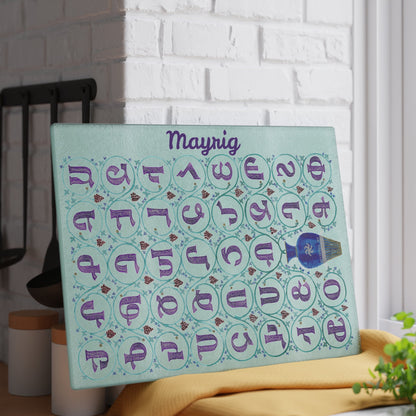 Mint Armenian alphabet cutting board with a name on a kitchen surface with herbs and stones nearby