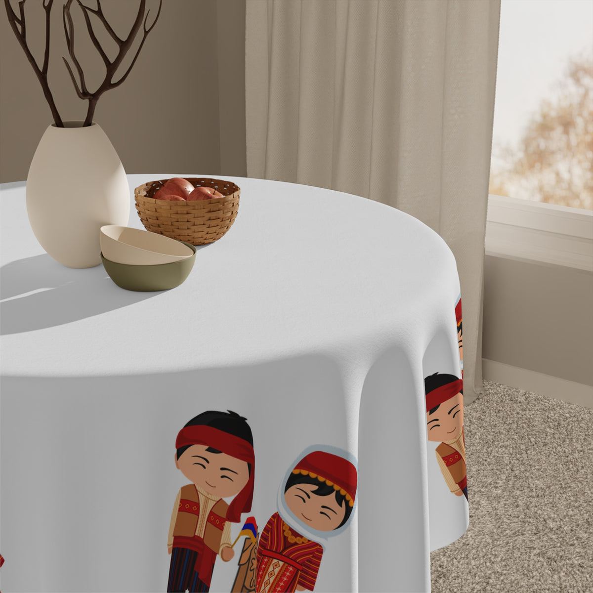 Armenian folk tablecloth with dress figures on a round dining table with a vase and a bowl of fruit