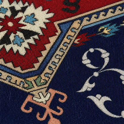 Close view of the red and cream star medallion with cream Armenian letters on navy