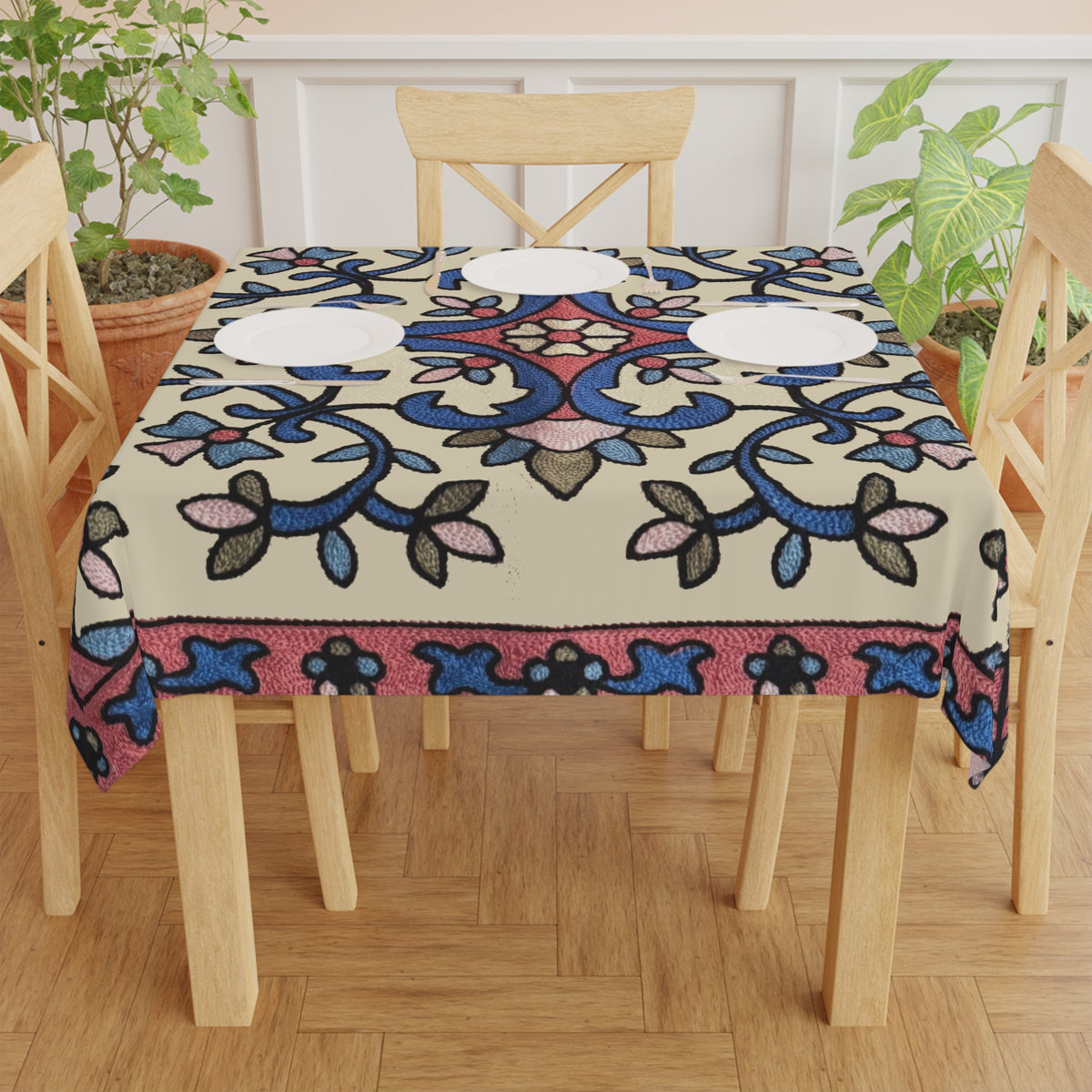Cream Armenian floral tablecloth on a round dining table with a vase and a bowl of fruit