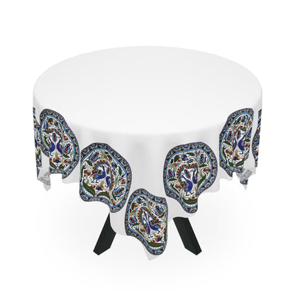 Armenian peacock medallion tablecloth on a rectangular table with wooden chairs and house plants