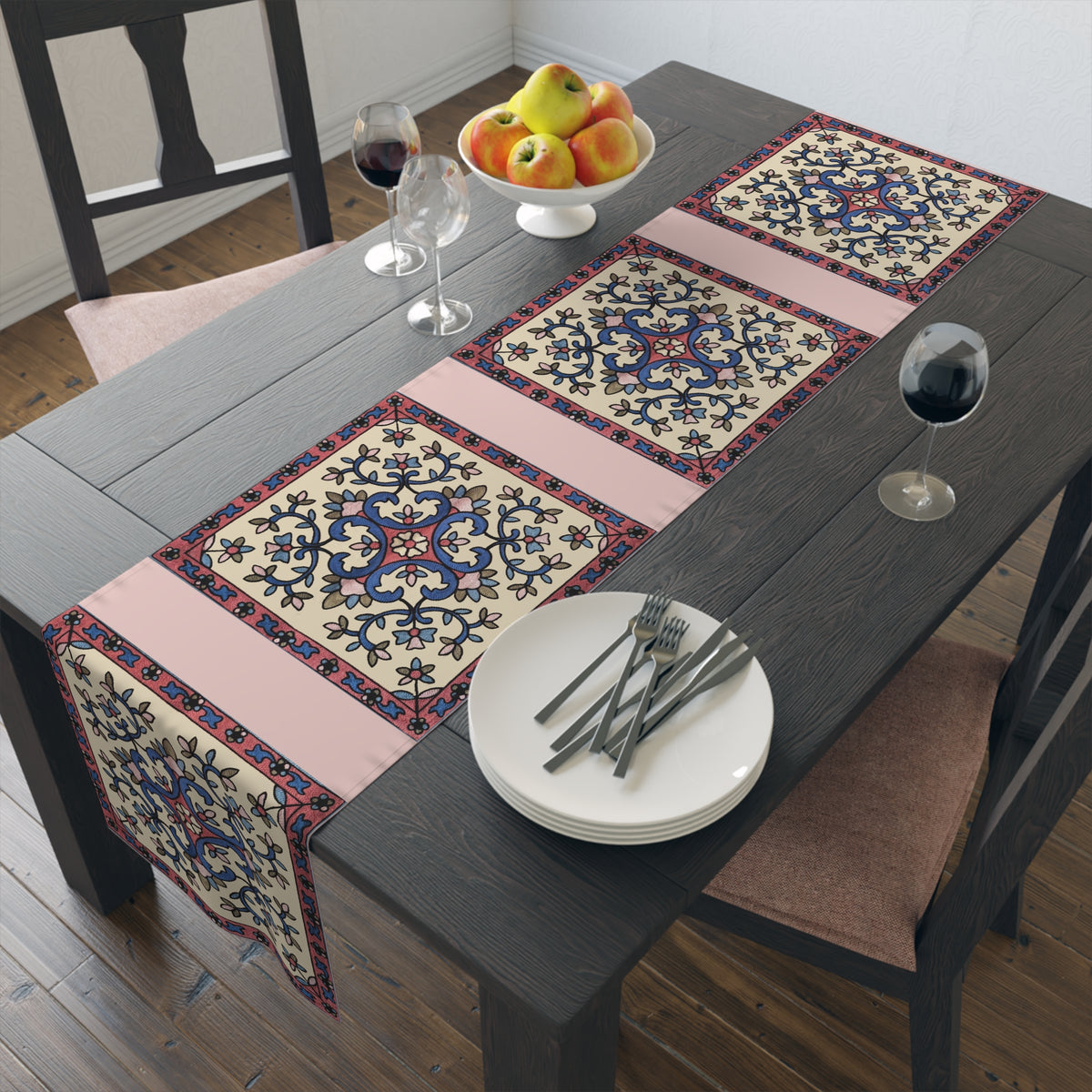 Cream Armenian floral table runner on a dining table with wooden chairs and a bowl of fruit
