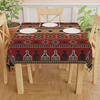 Armenian rug square tablecloth in deep red on a wooden dining table set with plates