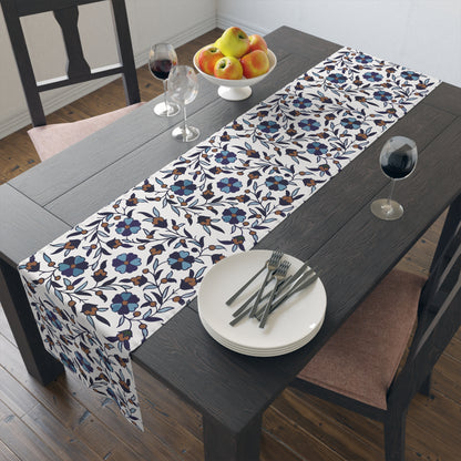 Cream Armenian Iznik poppy table runner on a dining table with wooden chairs and a bowl of fruit