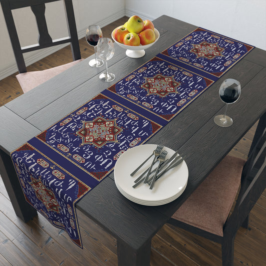 Armenian alphabet table runner in deep blue on a dining table set with white plates and glasses