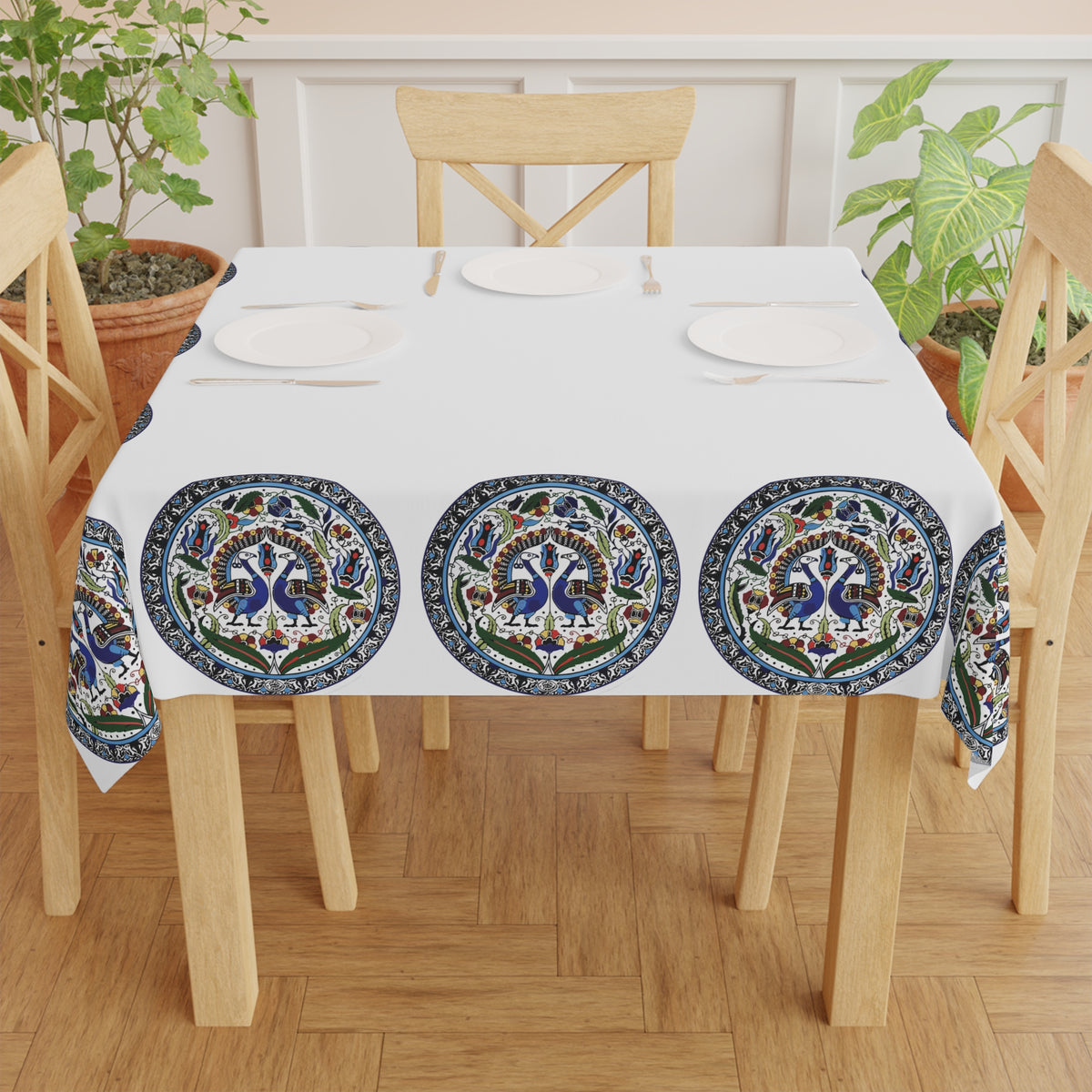 Armenian peacock medallion tablecloth draped over a round table beside a window