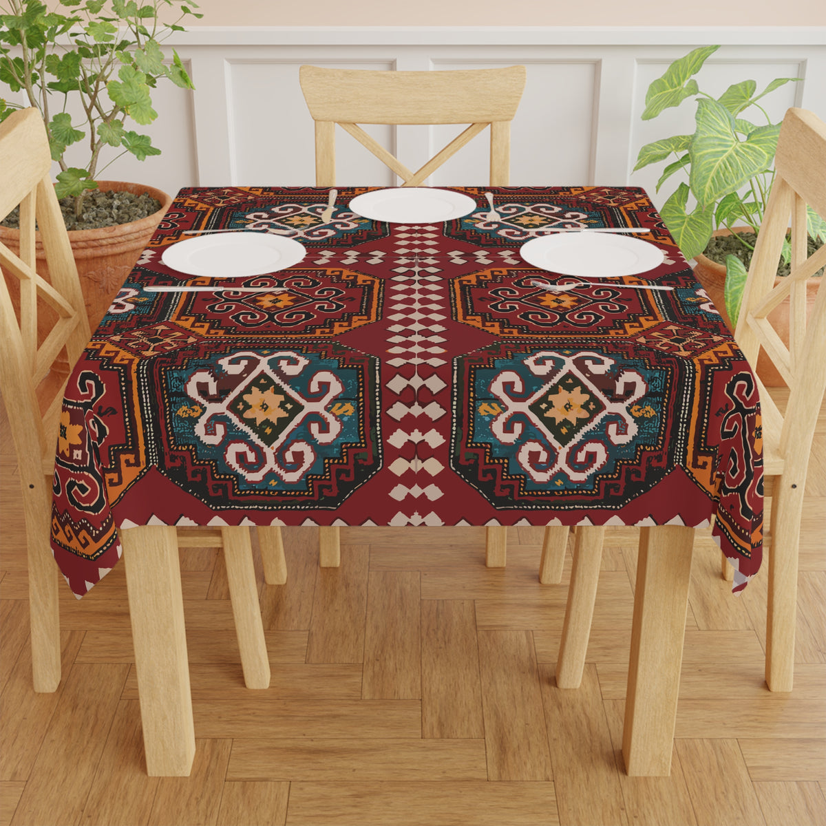 Burgundy Armenian rug design tablecloth draped over a round table beside a window