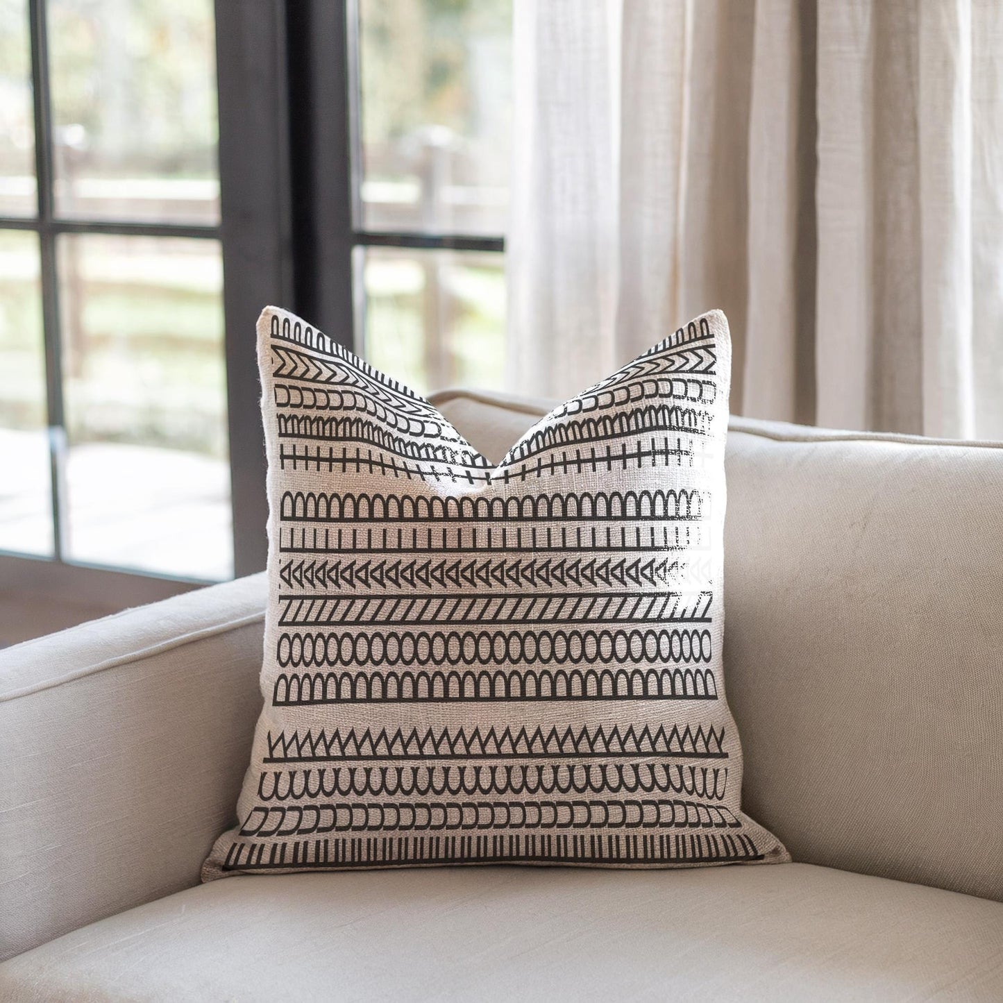 Modern Geometric throw pillow with geometric pattern styled on a sofa or bed