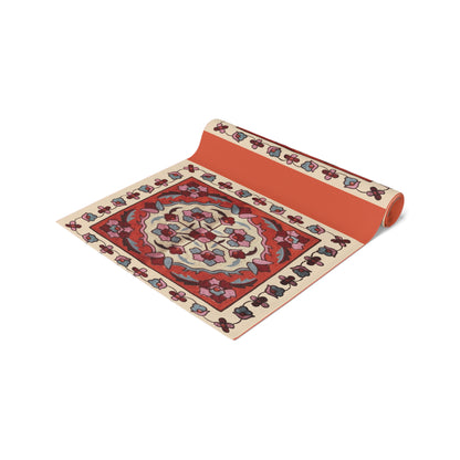 Western Armenian carpet table runner in red and cream on a dining table set with white plates and glasses