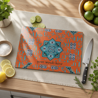 Orange and turquoise Armenian glass cutting board with a line of custom text, on a cloth with limes and a knife