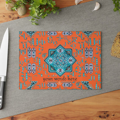 Orange and turquoise Armenian cutting board angled on a grey mat with a knife and garlic