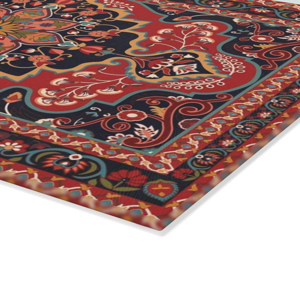Red and navy Armenian carpet cutting board on a wooden worktop with a knife alongside