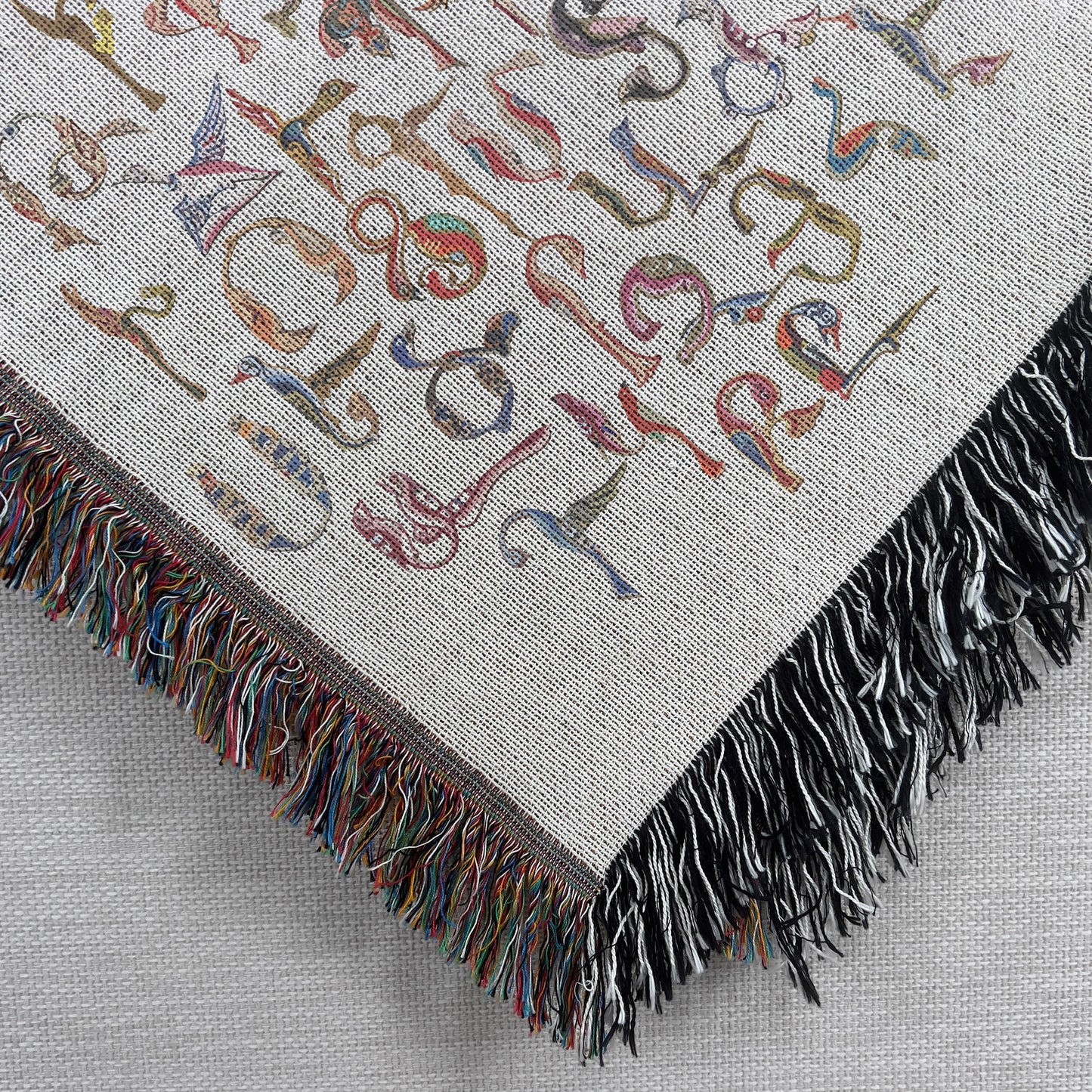 Boho woven blanket with woven pattern styled for layered home decor