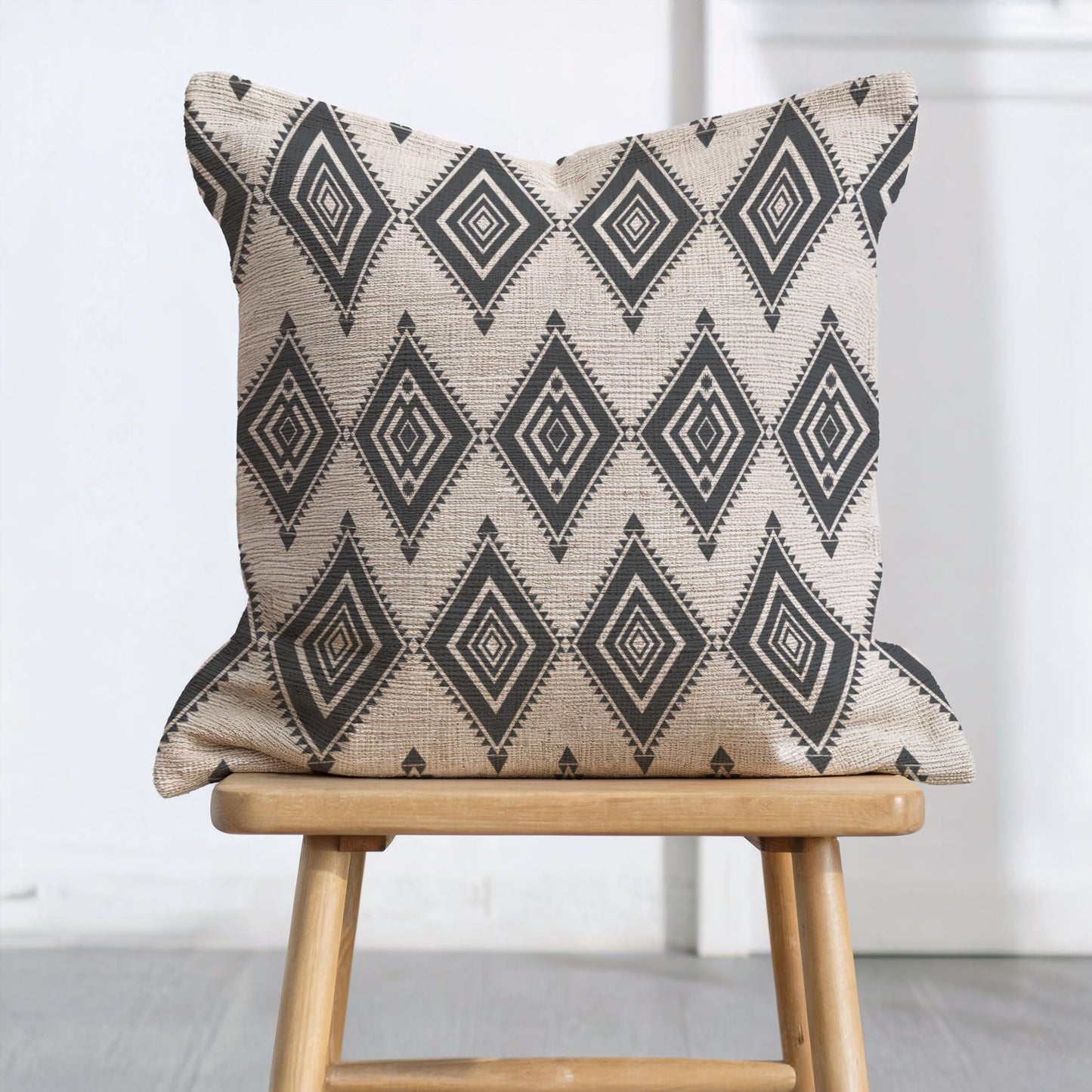 Southwestern throw pillow with geometric pattern styled on a sofa or bed