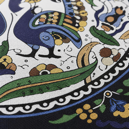 Close view of a medallion of paired blue peacocks with green leaves