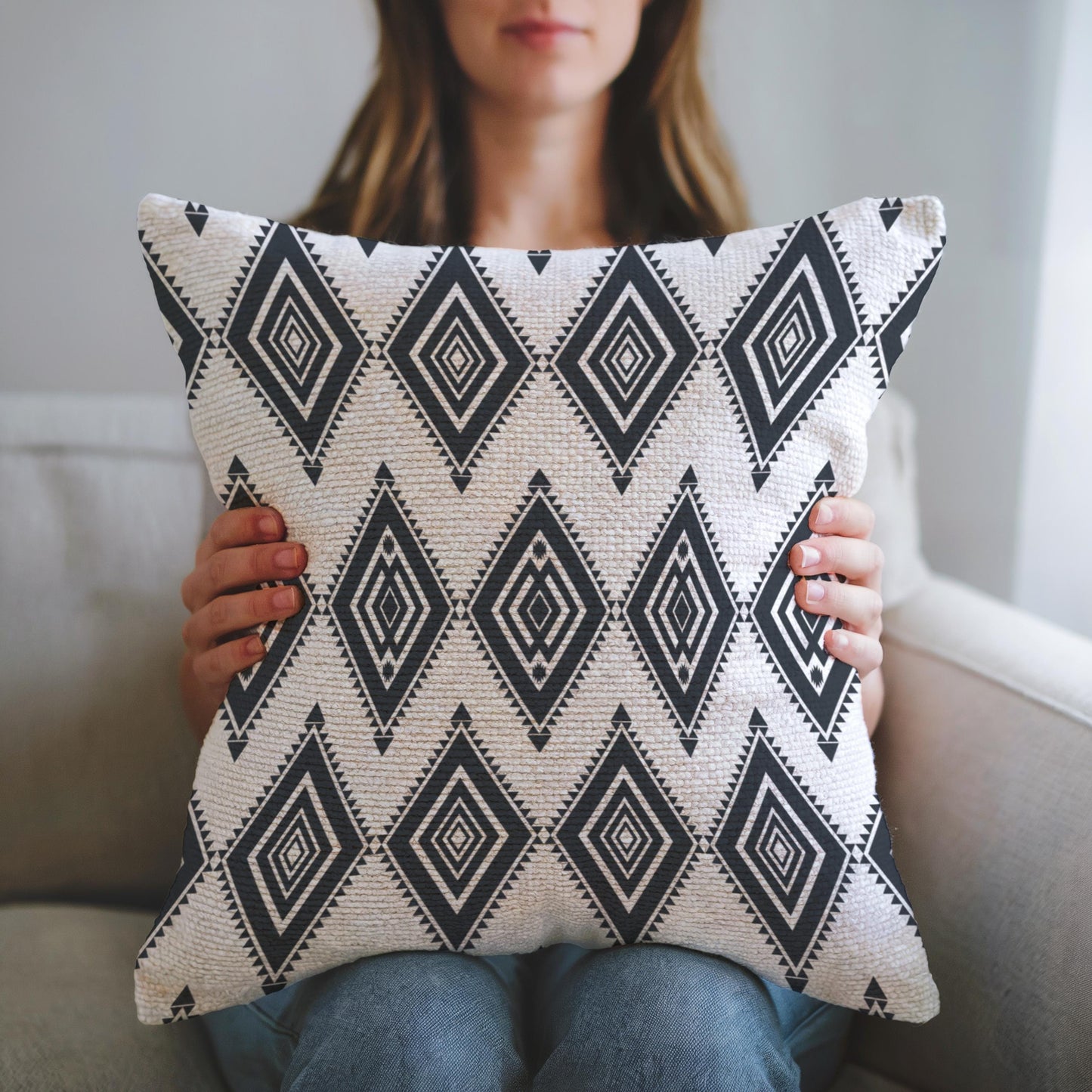 Southwestern throw pillow with geometric pattern styled on a sofa or bed