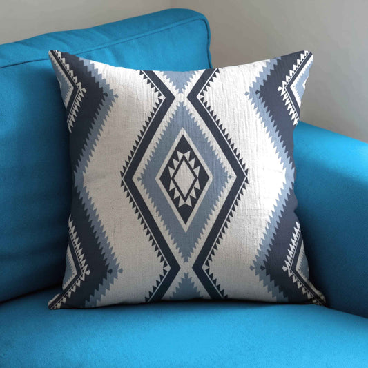 Southwestern pillow cover with geometric pattern styled on a sofa or bed