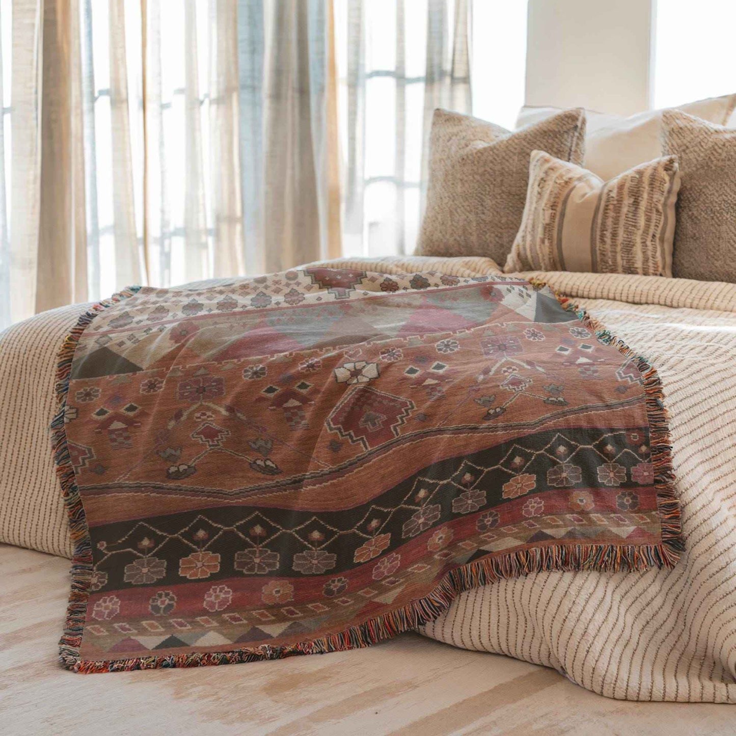 Southwestern woven blanket with geometric pattern styled for layered home decor
