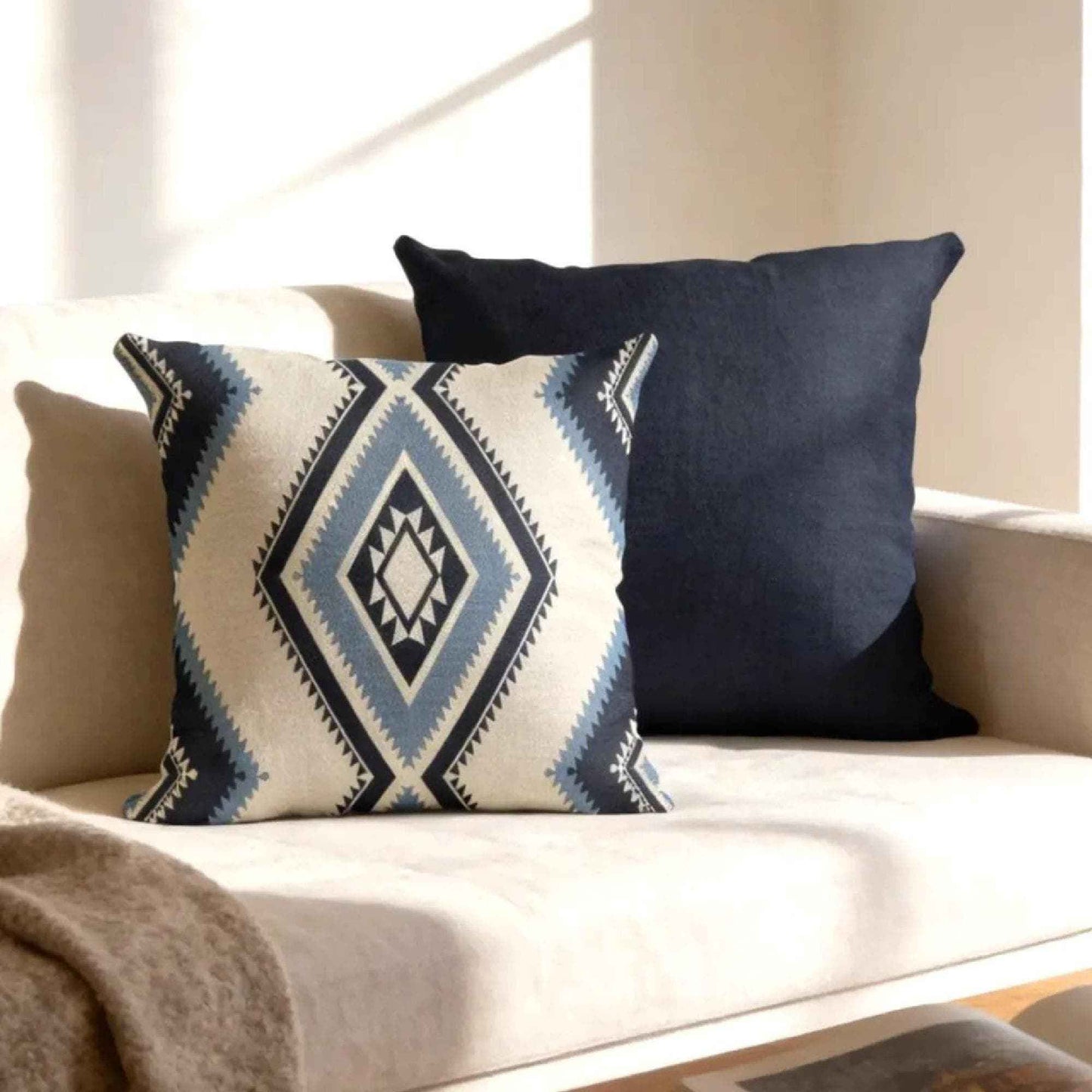Southwestern pillow cover with geometric pattern styled on a sofa or bed