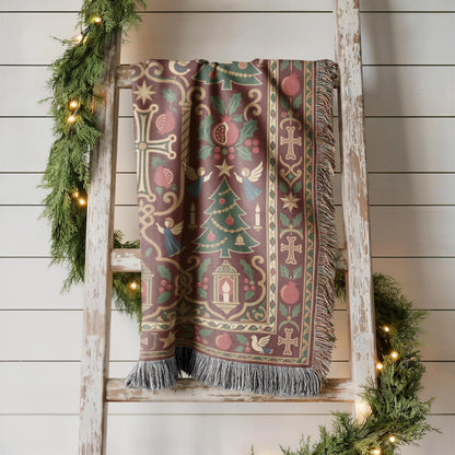 Armenian cross and Christmas tree woven blanket displayed on a wooden ladder against a white wall with greenery