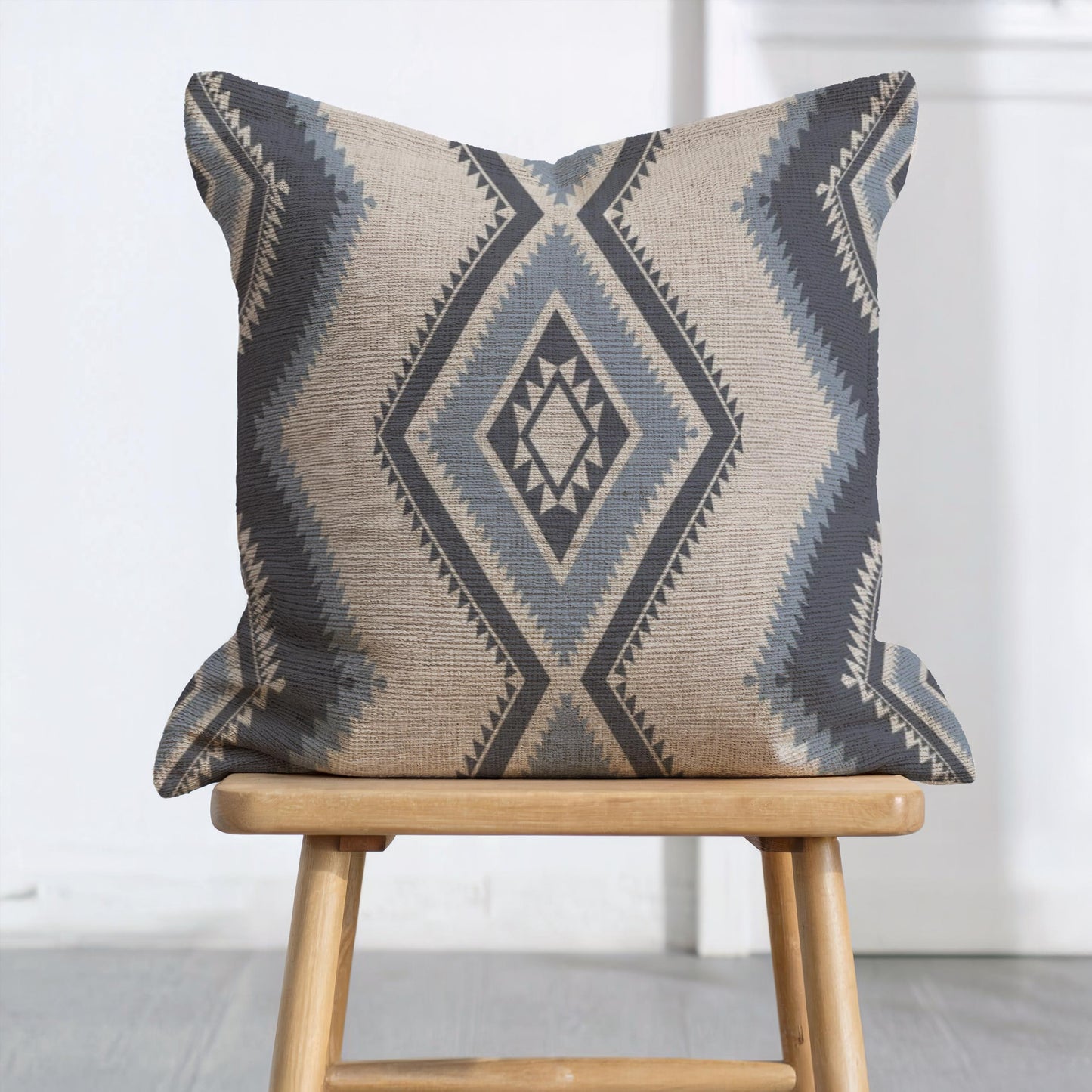Southwestern pillow cover with geometric pattern styled on a sofa or bed