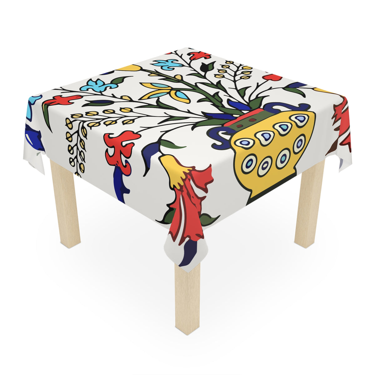 Yellow peacock Armenian tablecloth on a round dining table with a vase and a bowl of fruit
