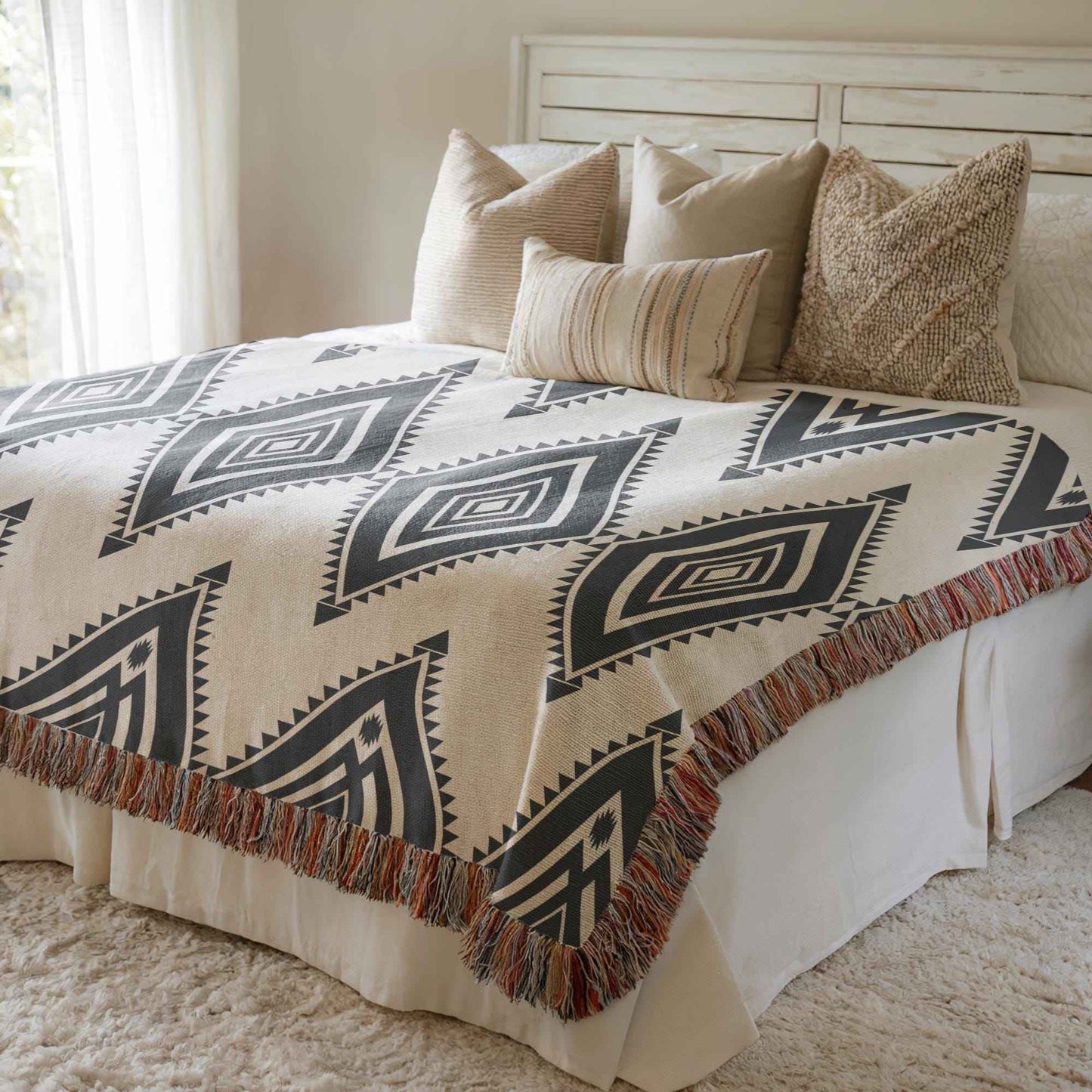 Southwestern woven blanket with geometric pattern styled for layered home decor