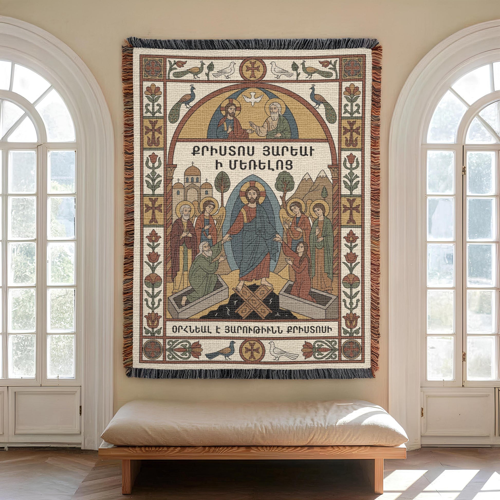 Tall arched windows flank Virgin Mary wall tapestry, bench beneath, ornamental borders and Armenian cross motifs visible.