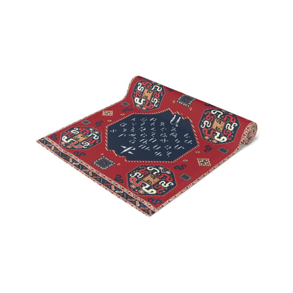 Armenian alphabet table runner in deep red on a dining table set with white plates and glasses