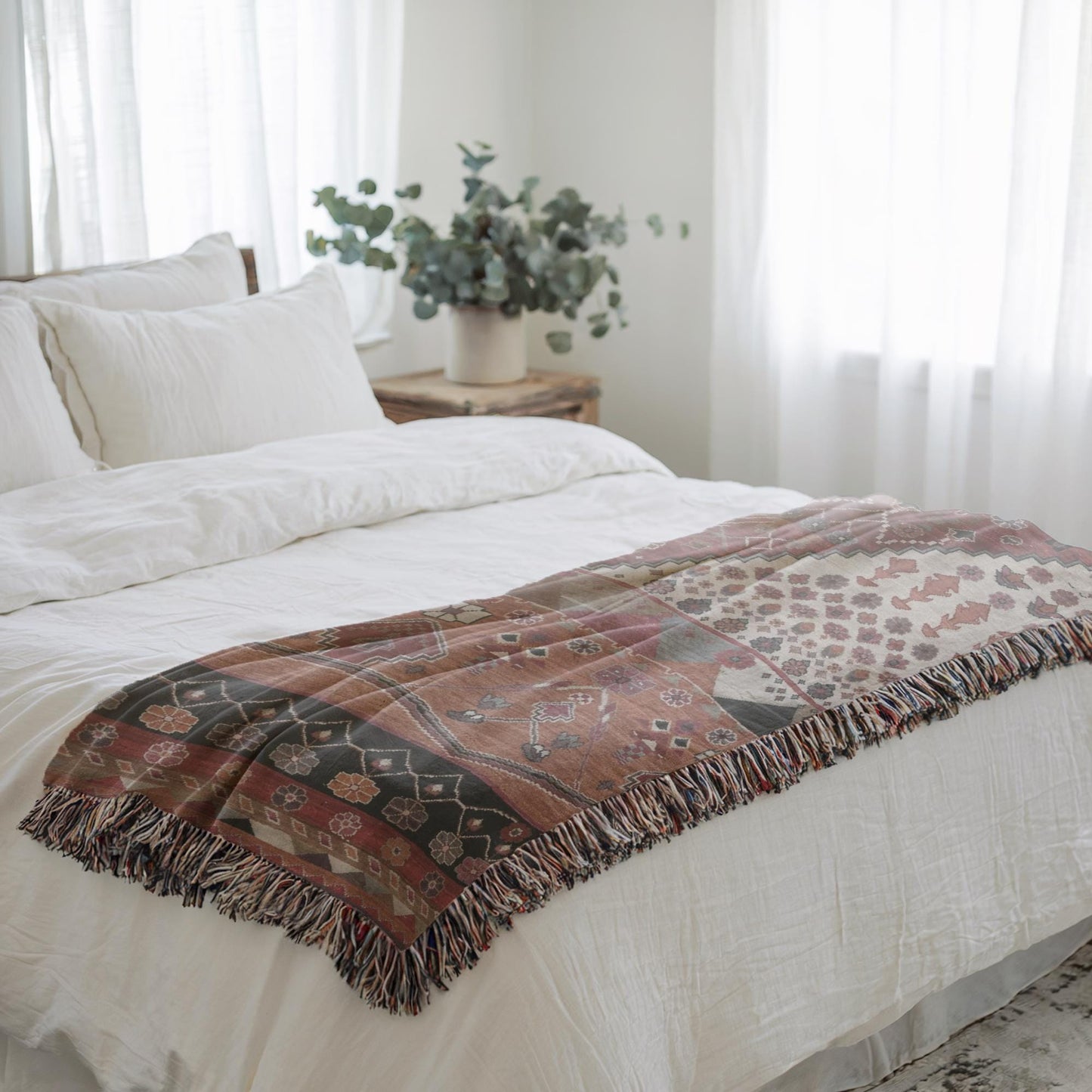 Southwestern woven blanket with geometric pattern styled for layered home decor