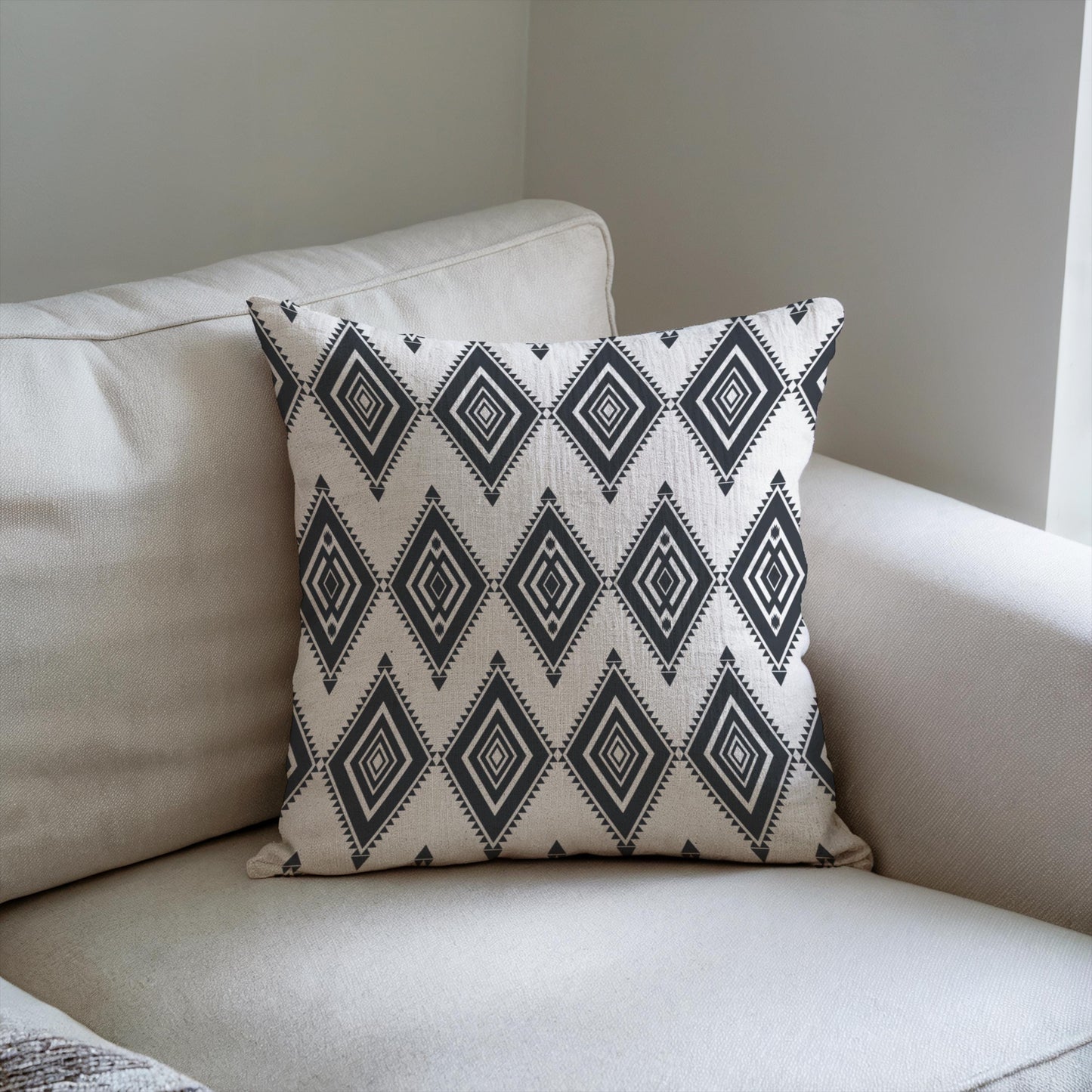 Southwestern throw pillow with geometric pattern styled on a sofa or bed