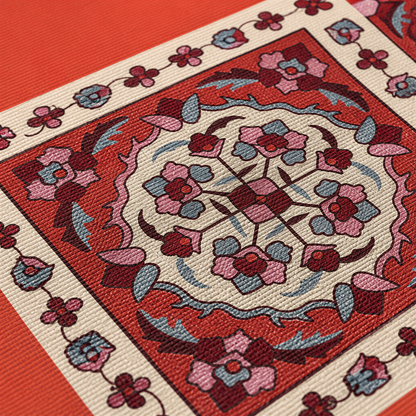 Close view of a deep red circular carpet medallion on orange and cream