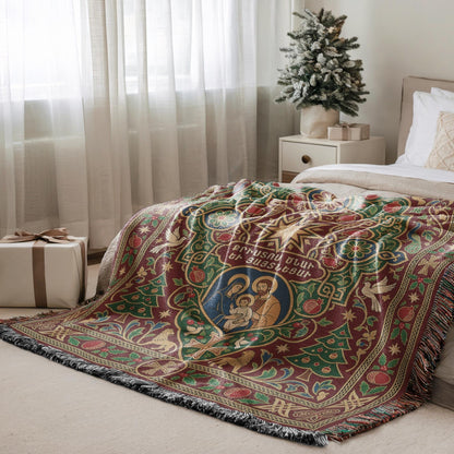 a cozy bedroom scene with a large, colorful blanket on a bed, a small Christmas tree, and a gift box on the floor.