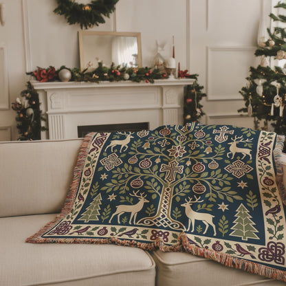 Armenian deer and pomegranate woven blanket draped over a beige sofa in a living room with a festive fireplace